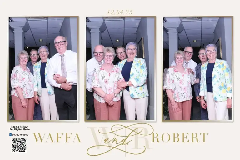 Wedding guests smiling in a personalized photo booth frame