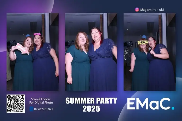 two women in black posing together at summer party photo booth