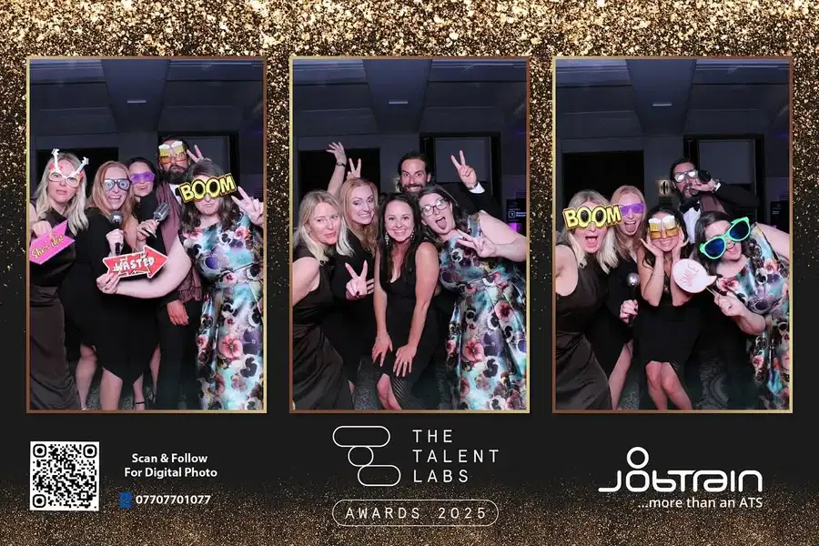 Group of guests using props in a Magic Mirror photo booth