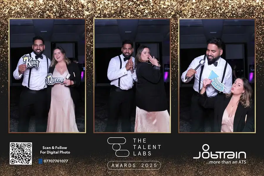 Guests posing with microphone props at a Magic Mirror photo booth