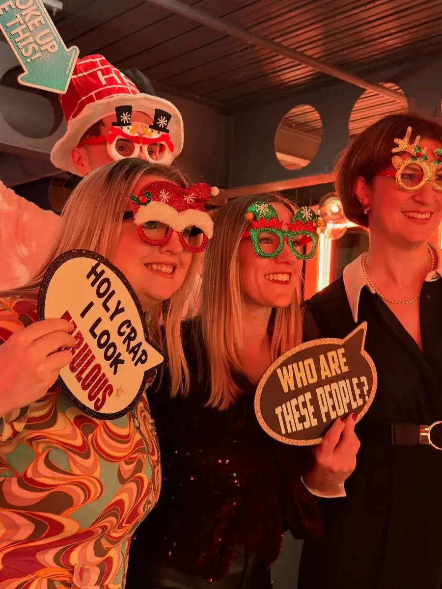 girls enjoying christmas while different tag in hands in Christmas booth hire