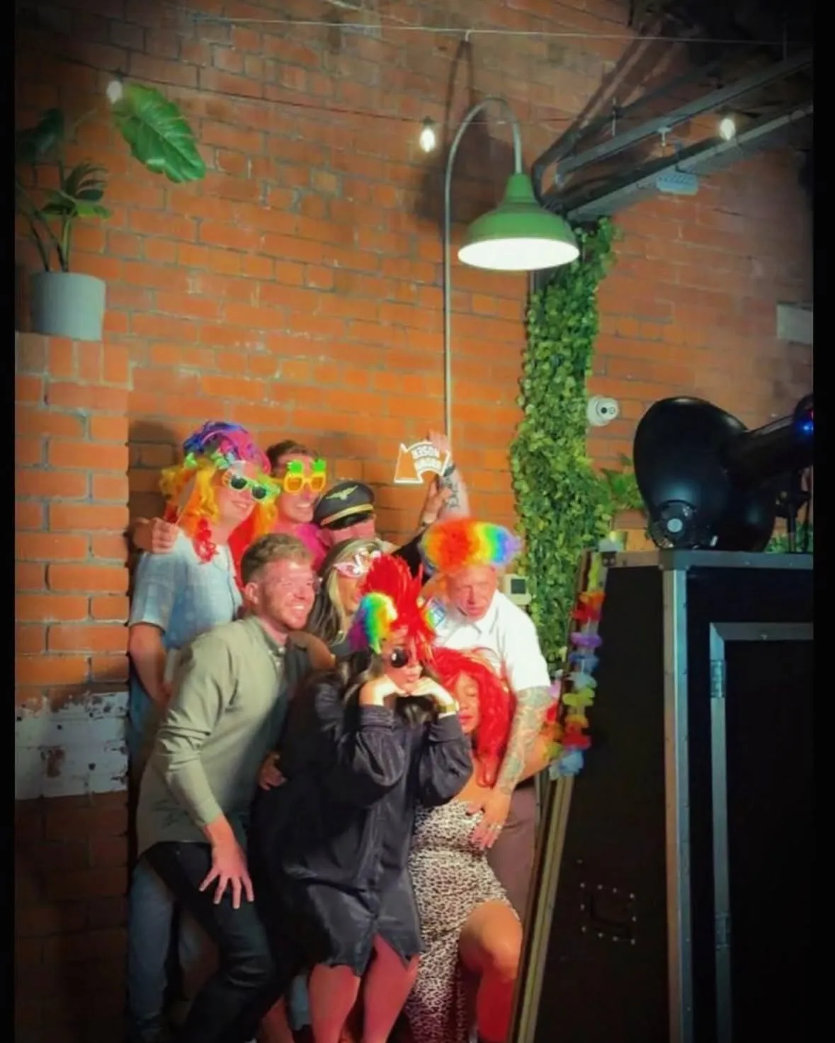 Colorful party props and event styling beside a Magic Mirror photo booth