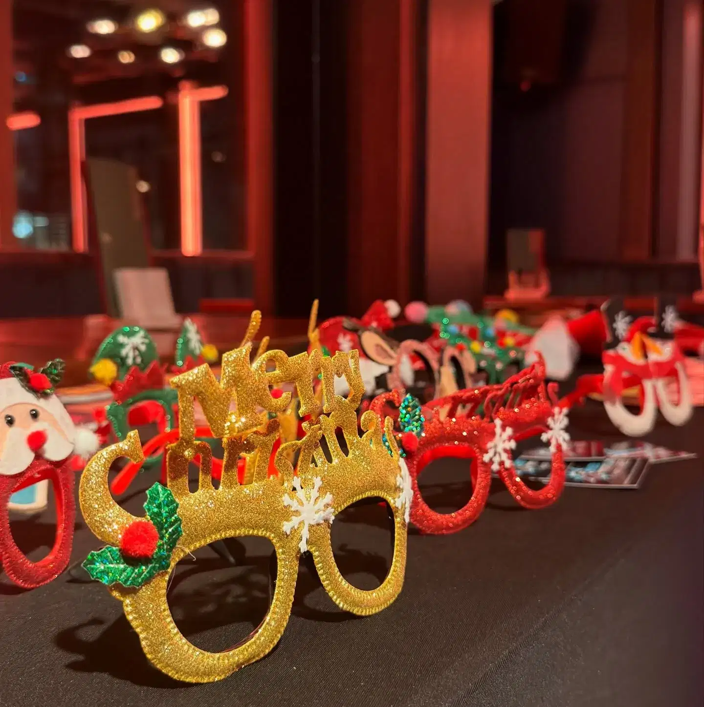 Table of colorful props ready for guests to use with the photo booth